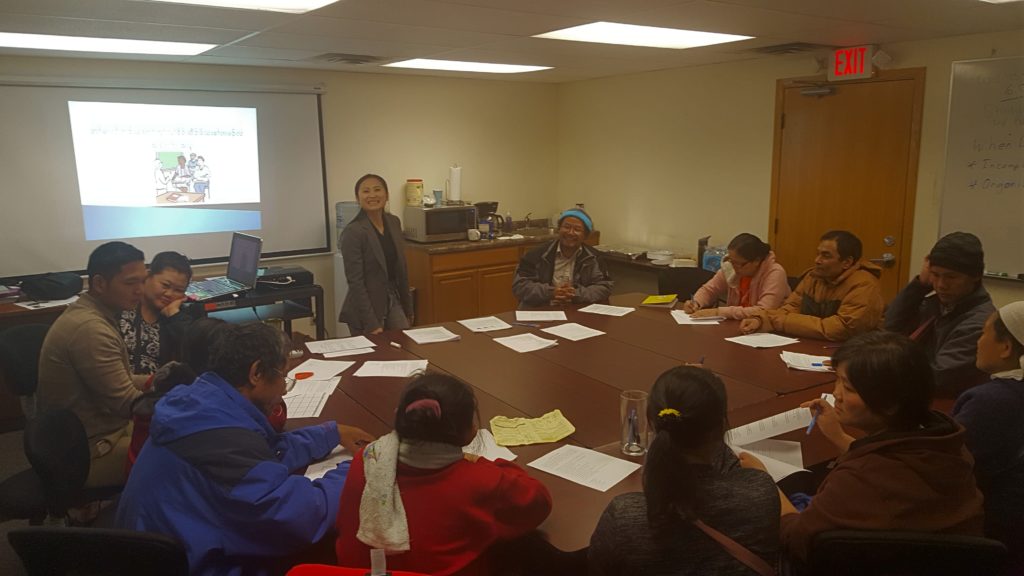 KOM staff Julyna Loo leading a parenting training class with Karen parents