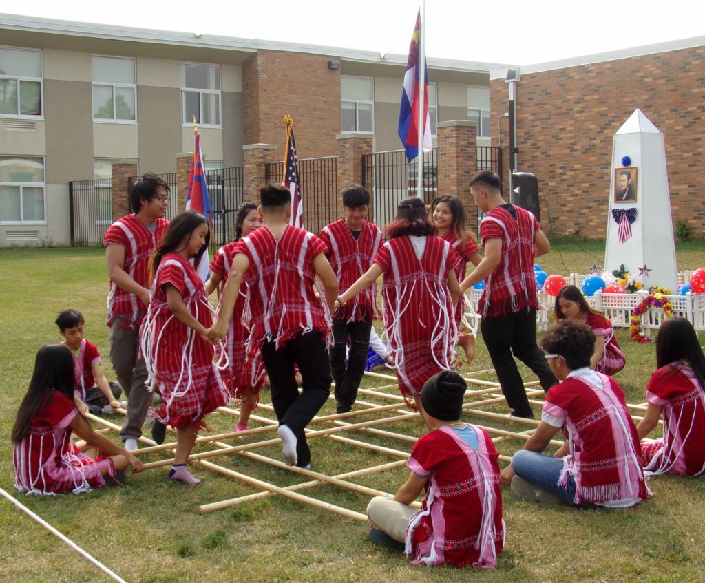 Karen youth dancers perform the bamboo dance at Karen Martyr's Day