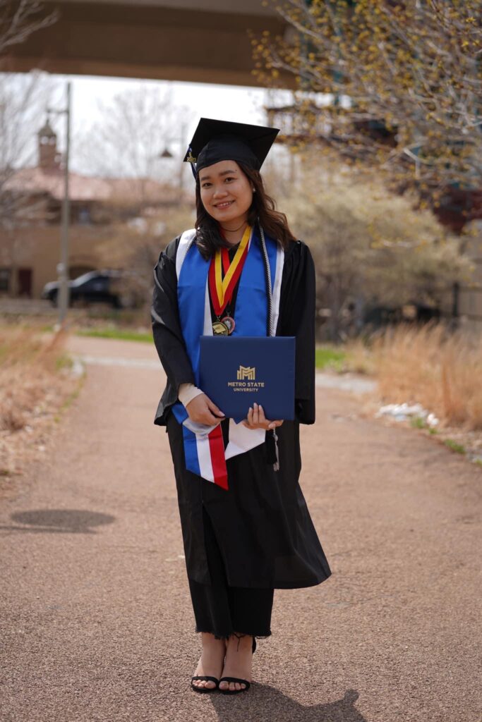 Photo 4: La Lu Moo in her cap and gown after graduating from Metro State University in Saint Paul.