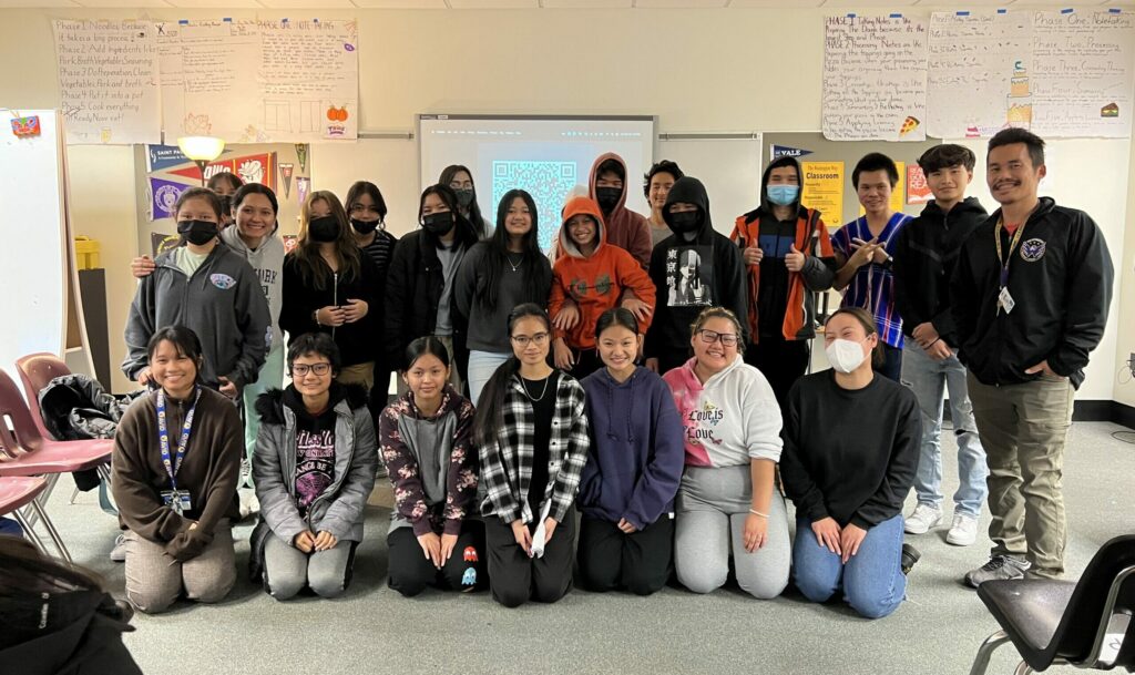 Photo 1: Bright and enthusiastic students thriving in our after-school program. Pictured with youth coordinator, Mular Lerpwel, on the bottom right.