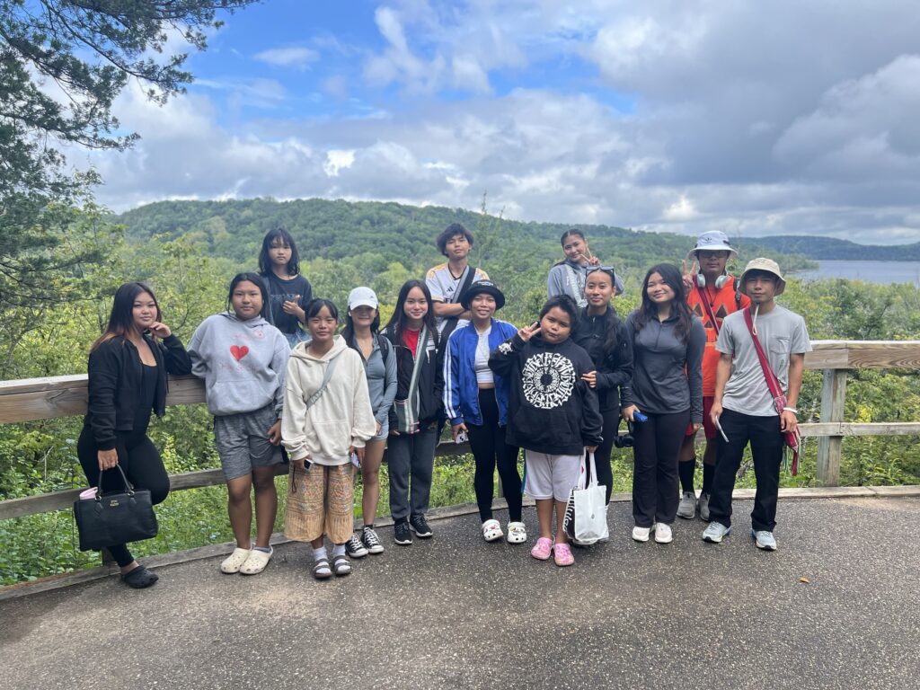 KOM youth pose and staff at the top of their hike in August 2024 at Afton State Park.