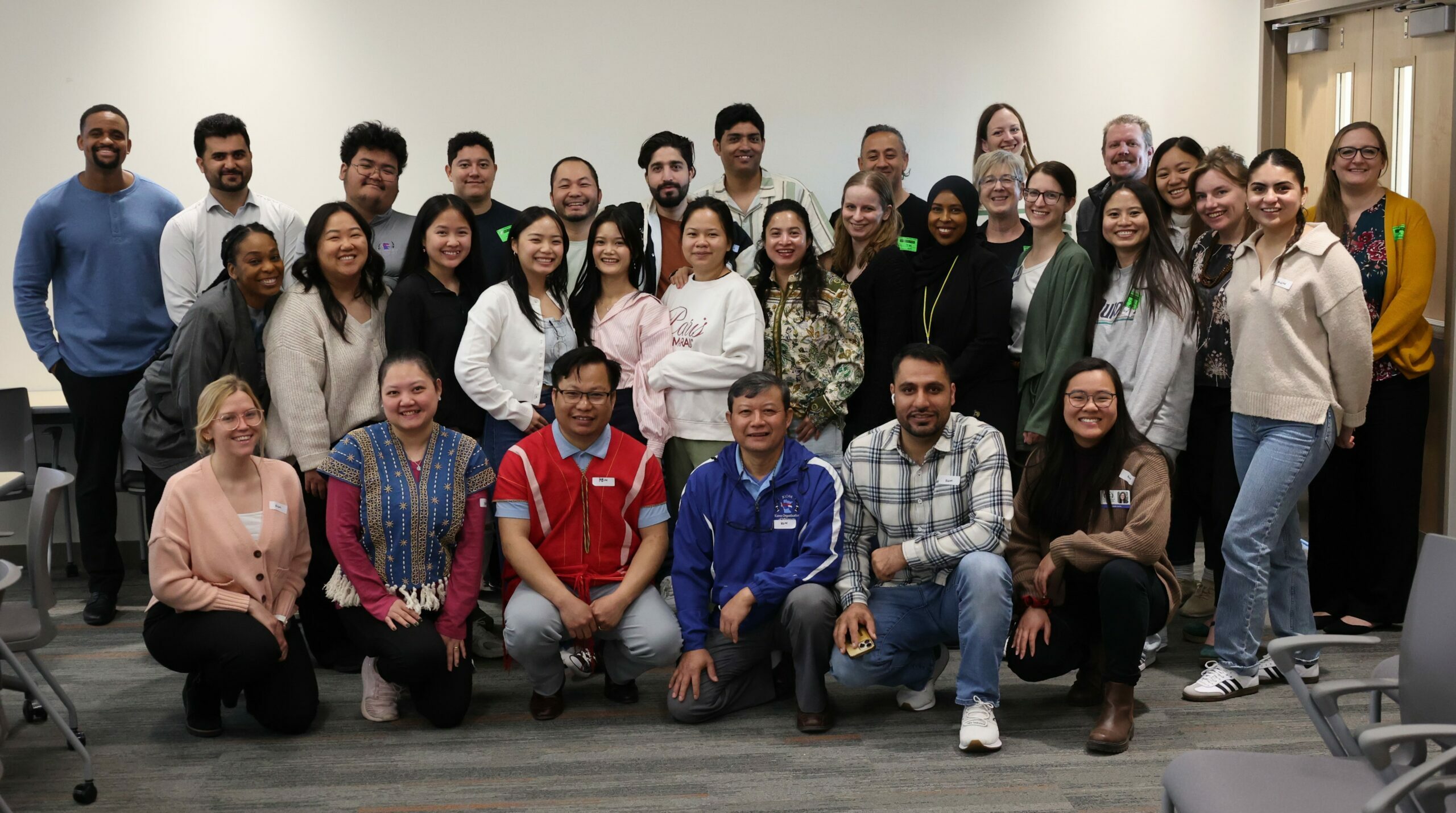 A large group of KOM staff members posing for a photo.